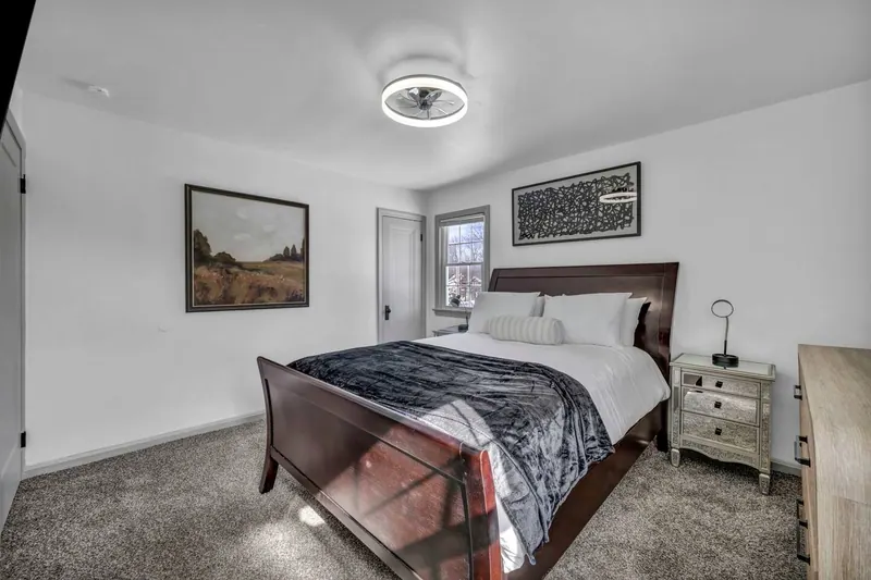 Second bedroom with a queen sleigh bed and a framed print